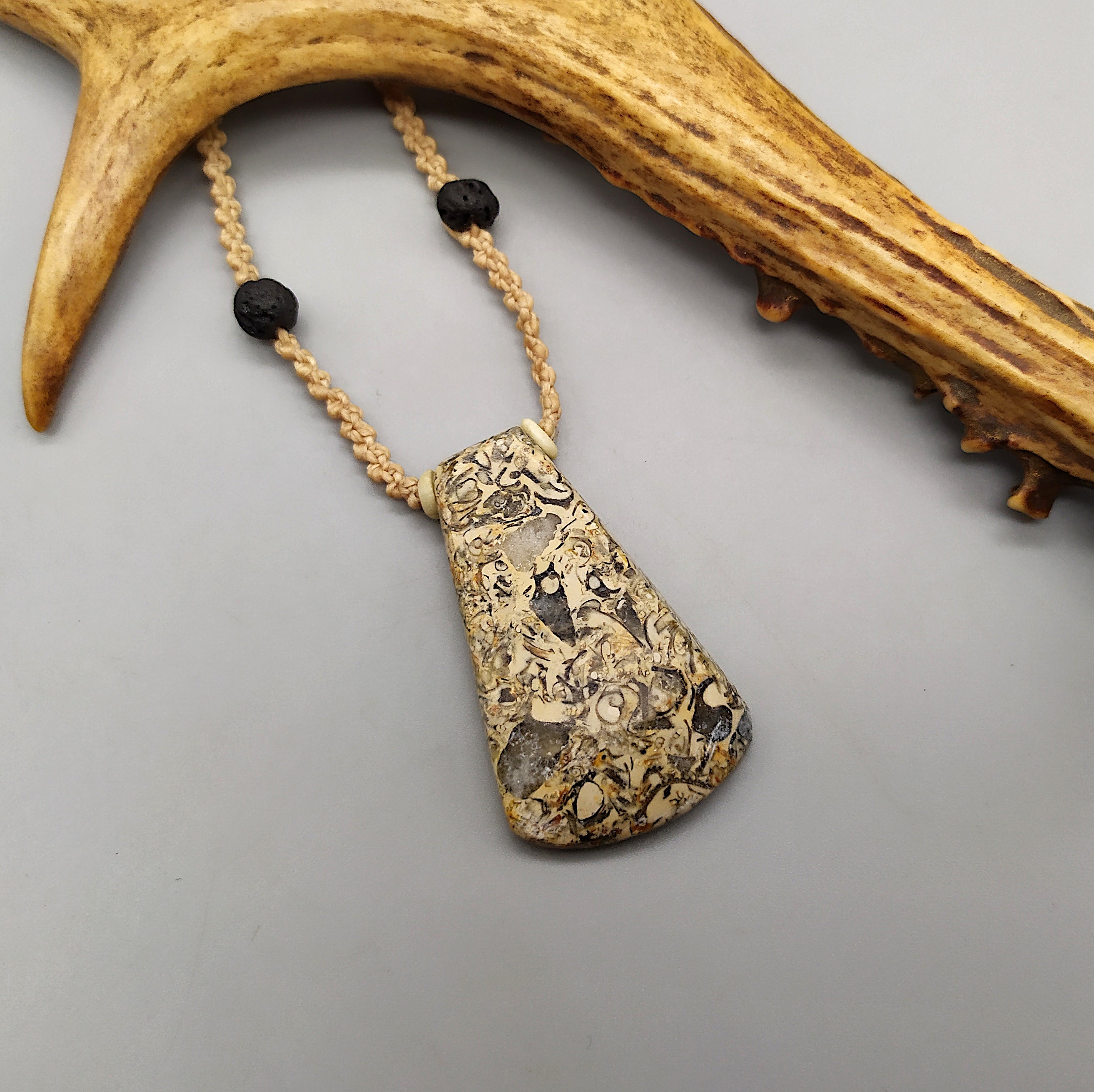 Collana con ascia in pietra fossile